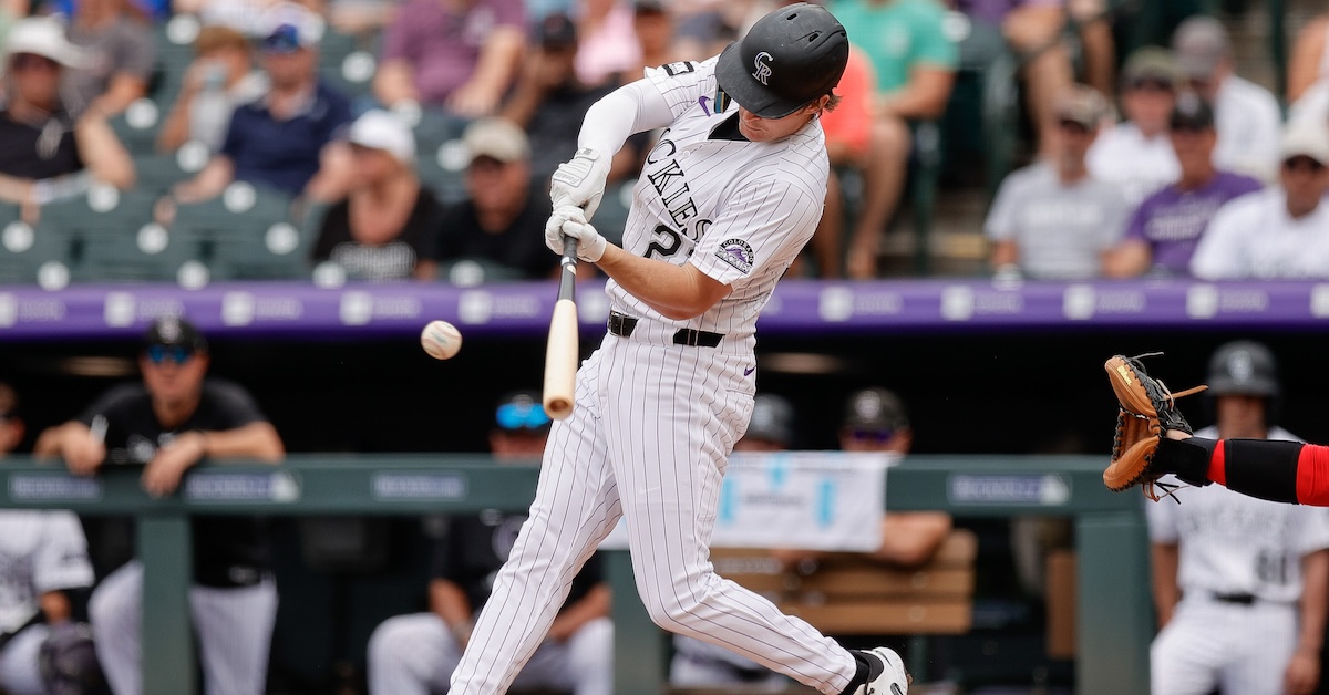 Jul 23, 2025; Denver, Colorado, USA; Colorado Rockies center fielder Mickey Moniak (22) hits an RBI single in the second inning against the St. Louis Cardinals at Coors Field.